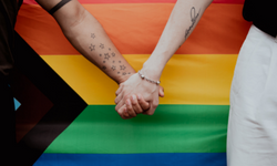 rainbow flag with people holding hands